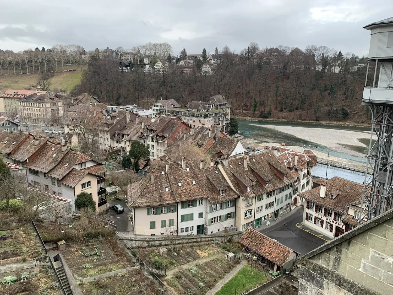 Red-tiled roofs of the Matte quarter in Bern beside the turquoise Aare river