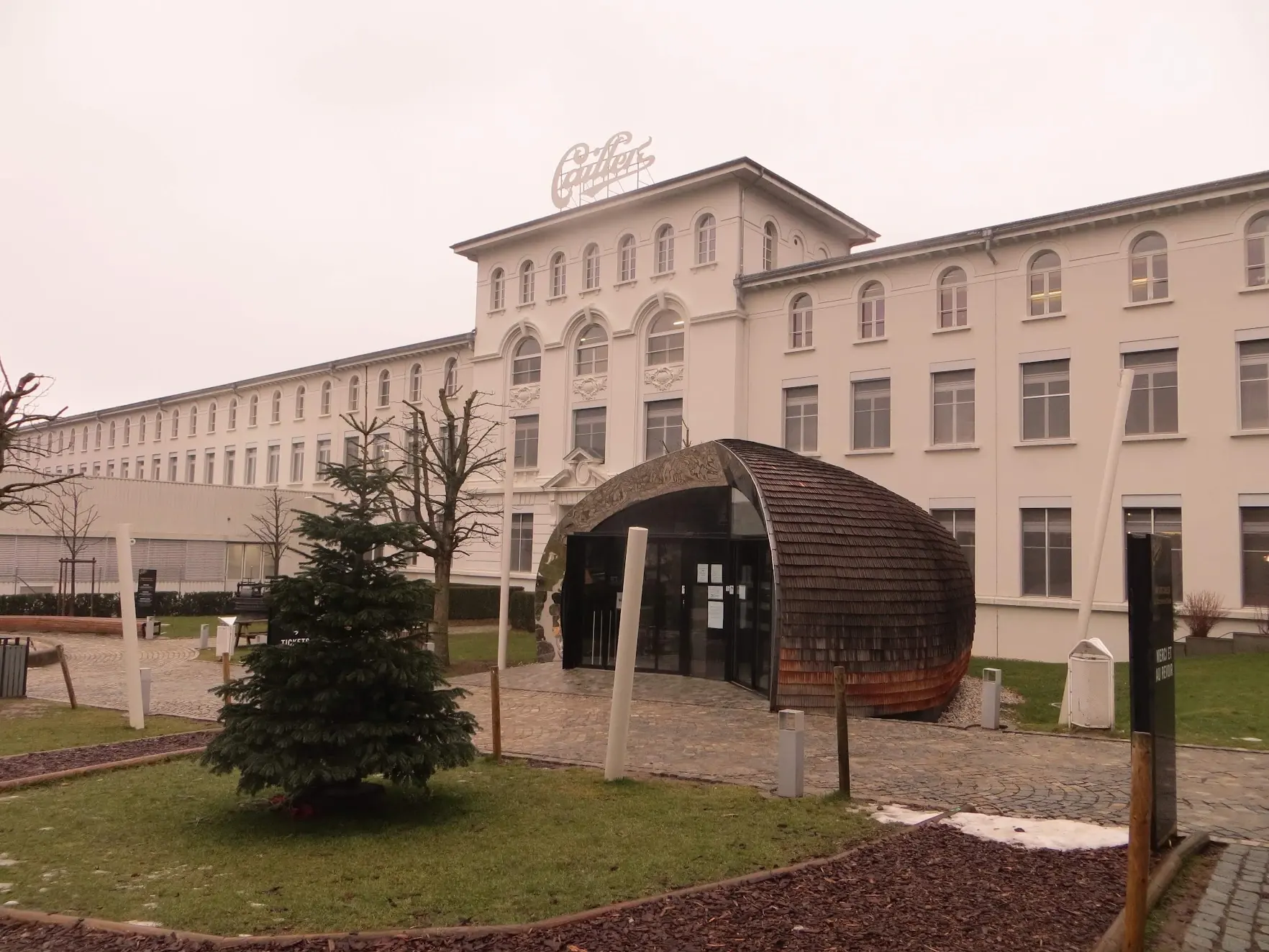 The Cailler chocolate factory in Broc, a long white building with the Cailler logo on the roof