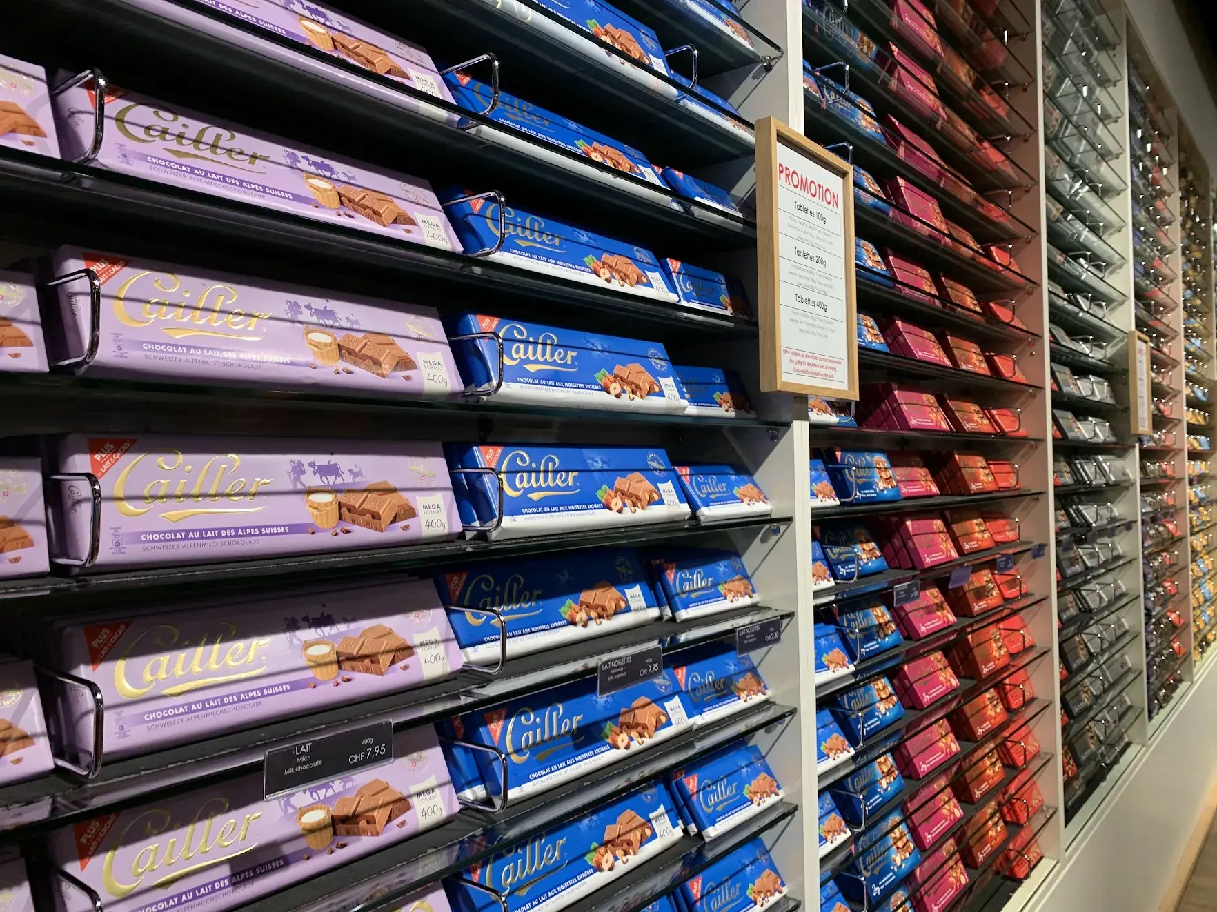 A wall of Cailler chocolate bars in purple, blue and red wrappers, with prices in Swiss francs