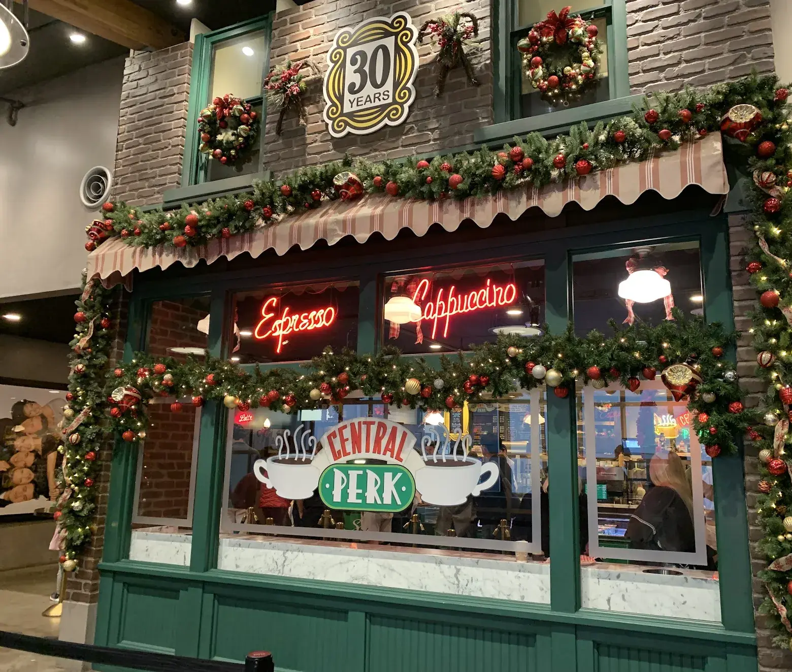 The Central Perk café from Friends decorated with Christmas garlands and a 30 Years sign