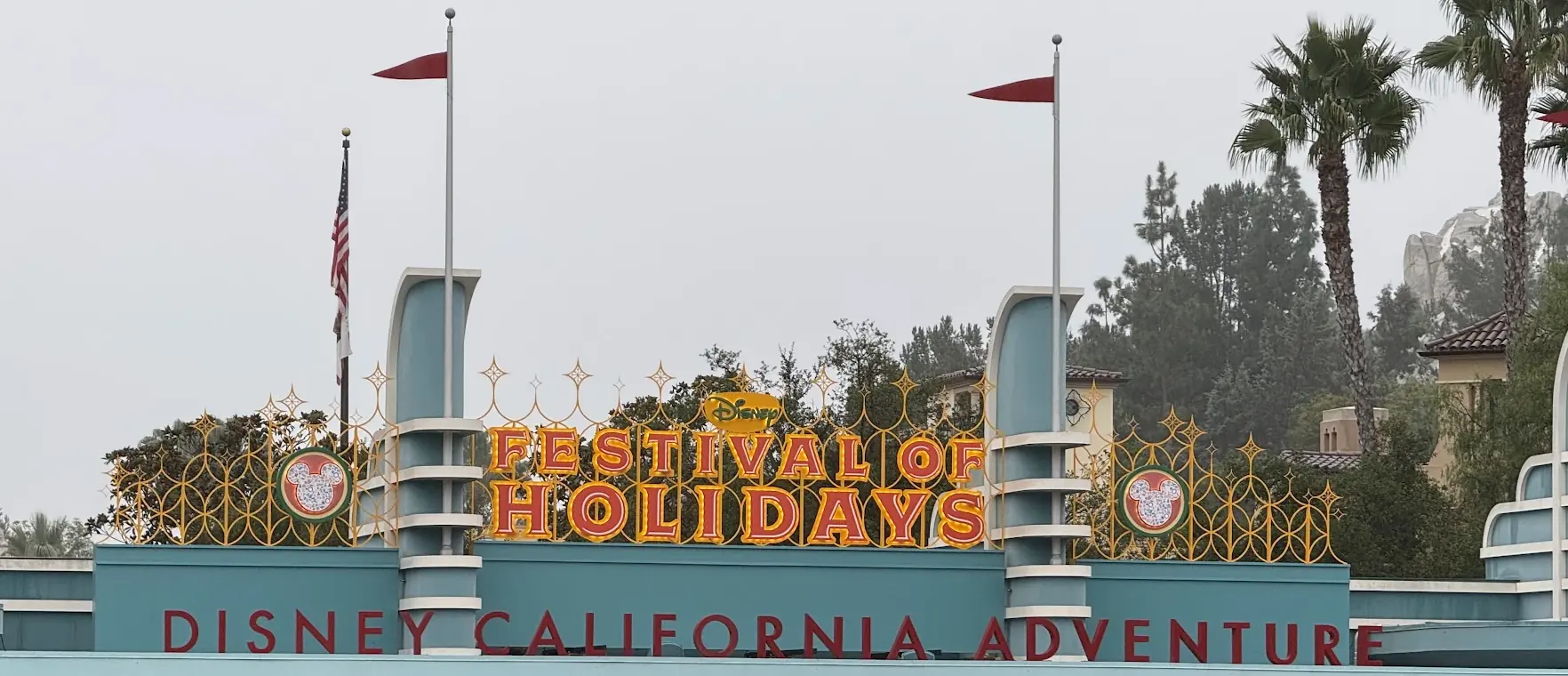 The Disney California Adventure entrance with a Festival of Holidays sign
