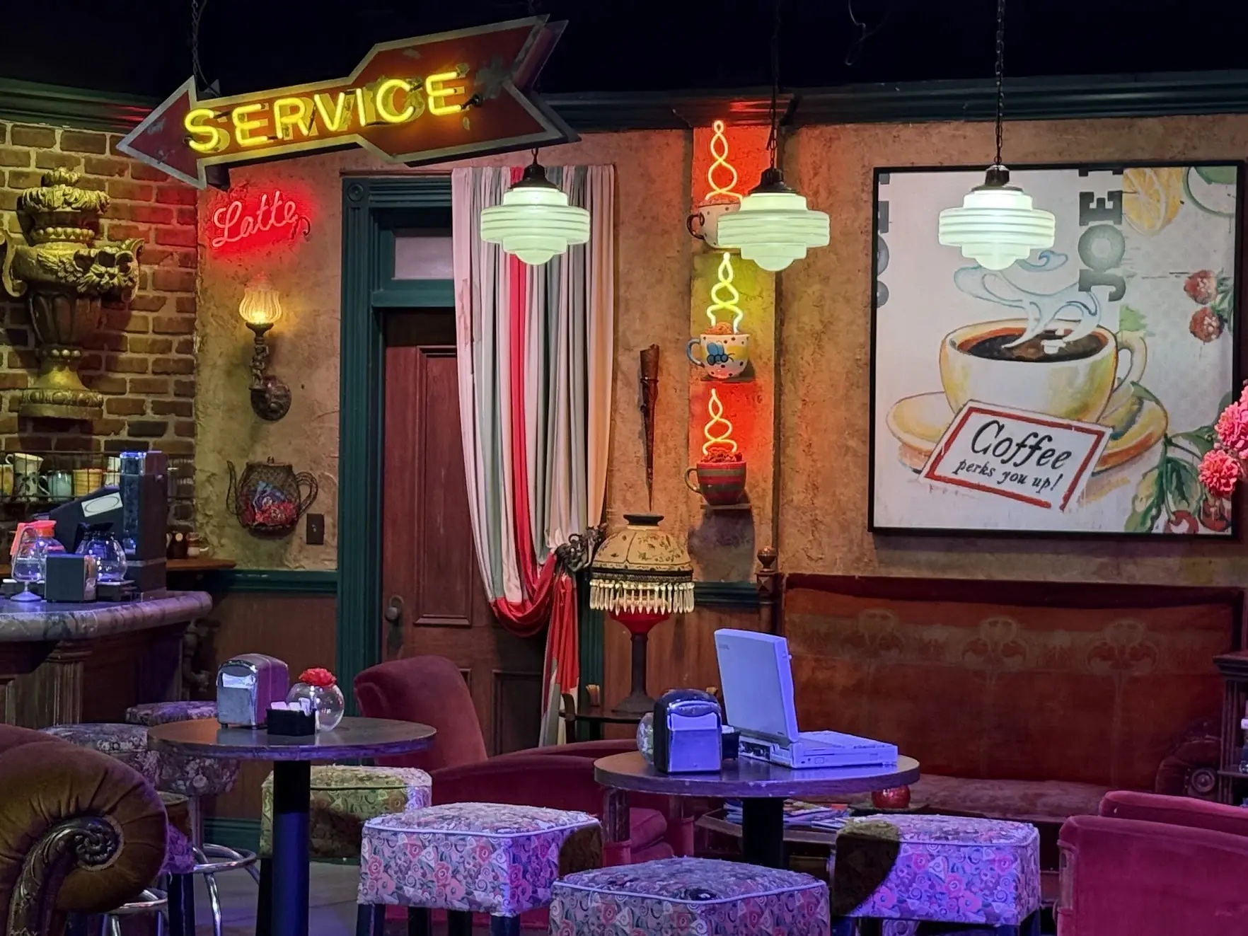The Central Perk set from Friends, with neon signs, armchairs and patterned stools