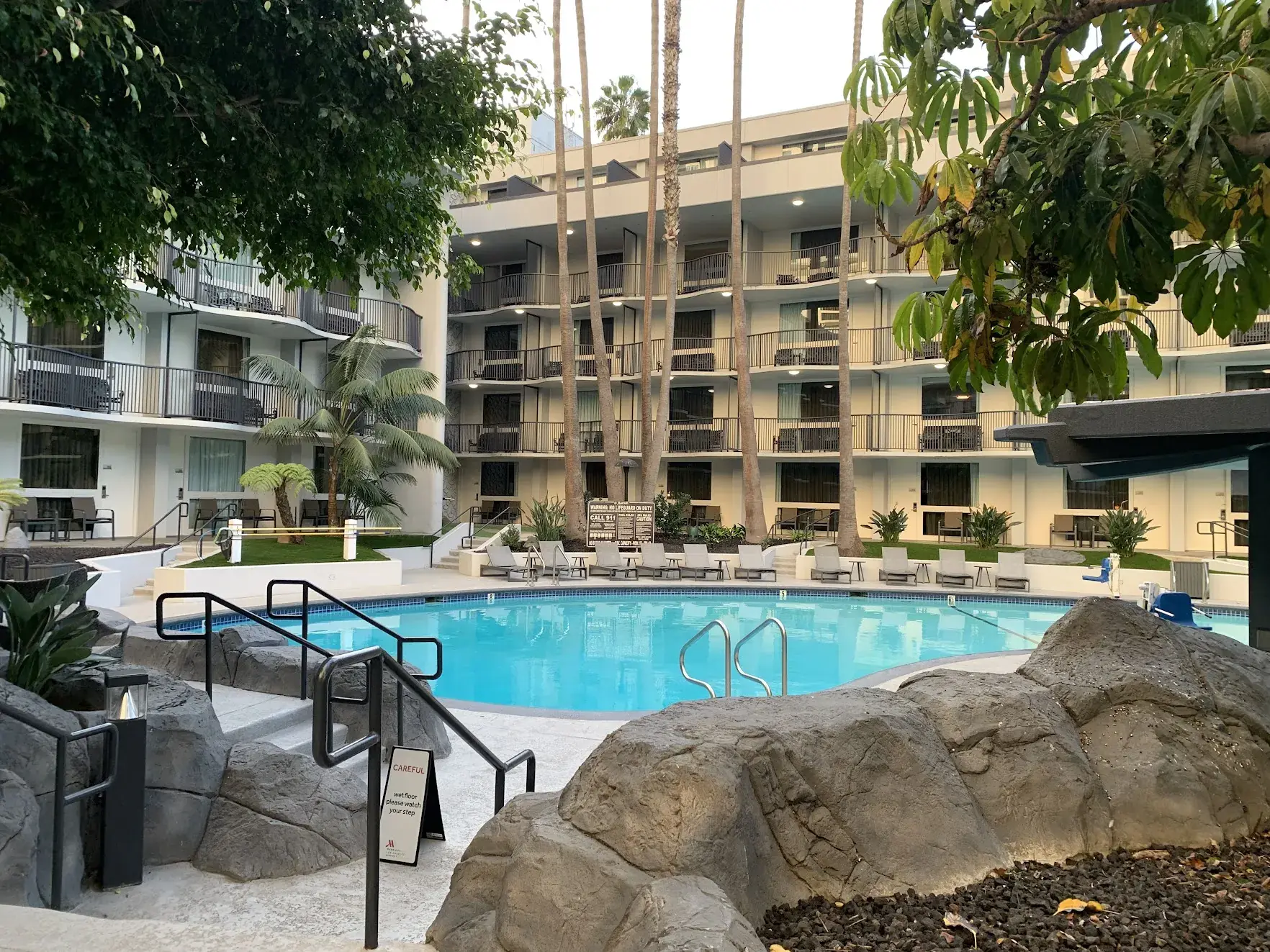 The courtyard pool at the Los Angeles Airport Marriott, surrounded by palm trees and balconies
