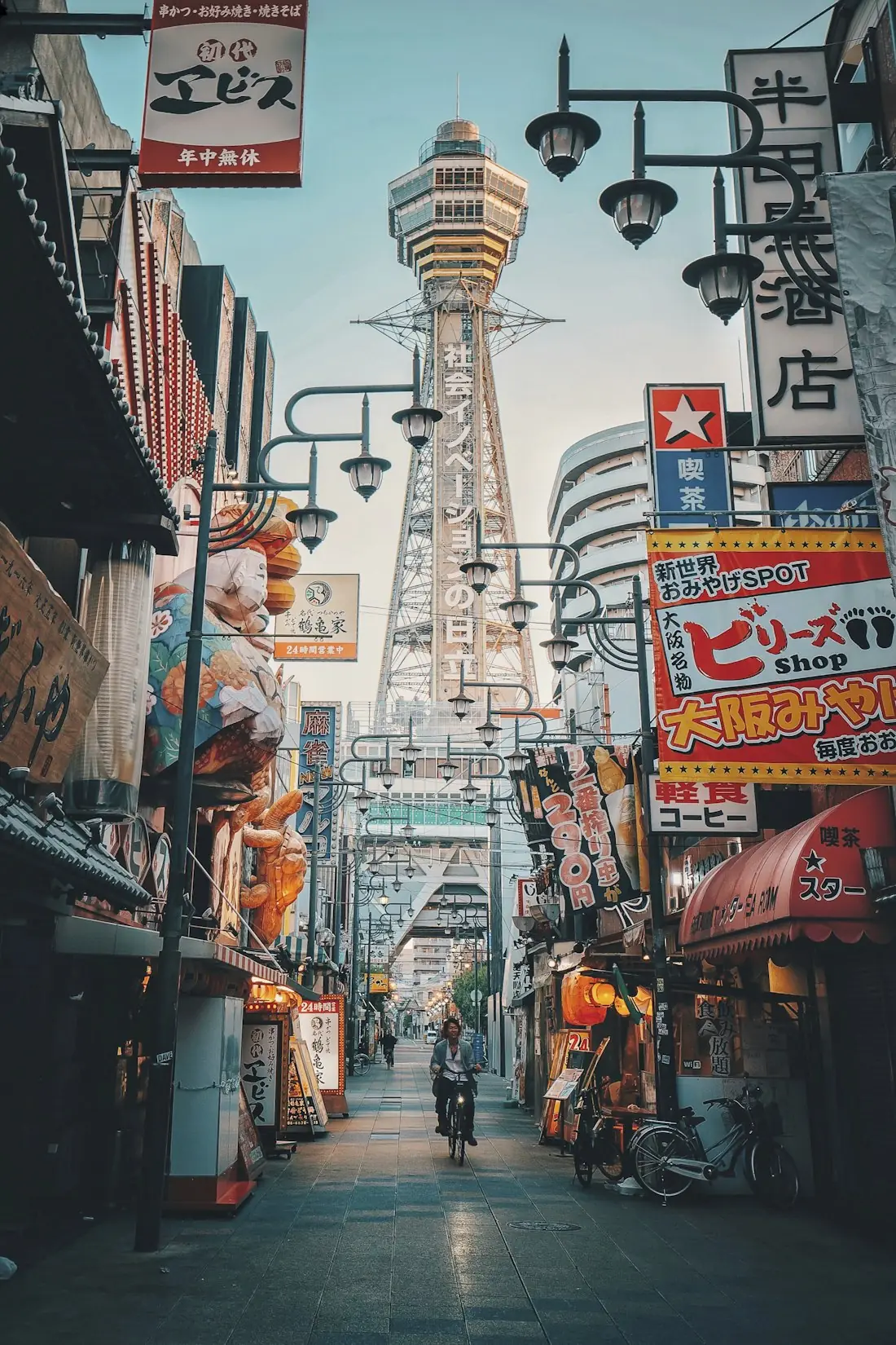 Shinsekai street in Osaka with Tsutenkaku Tower and colorful shop signs